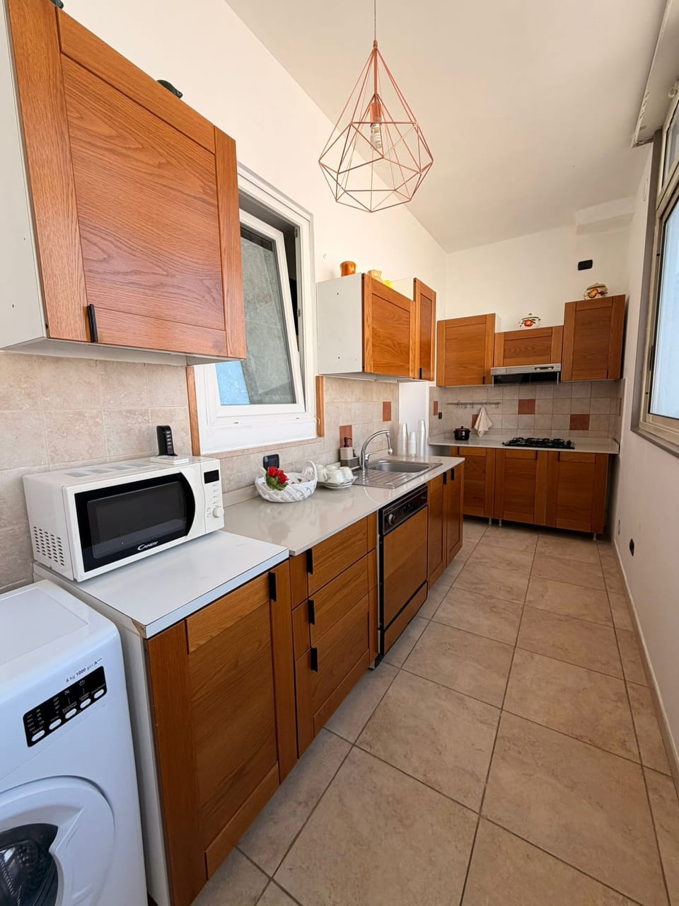 Full-size fridge, microwave, stovetop, cookware/dishes/utensils