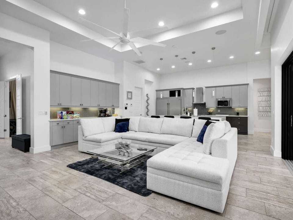 The open-concept living area offers plenty of comfortable seating, modern finishes, and an easy flow into the kitchen.