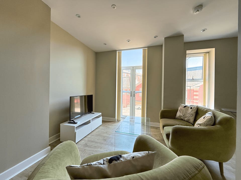 Standard Apartment | Living area | 40-inch flat-screen TV with cable channels