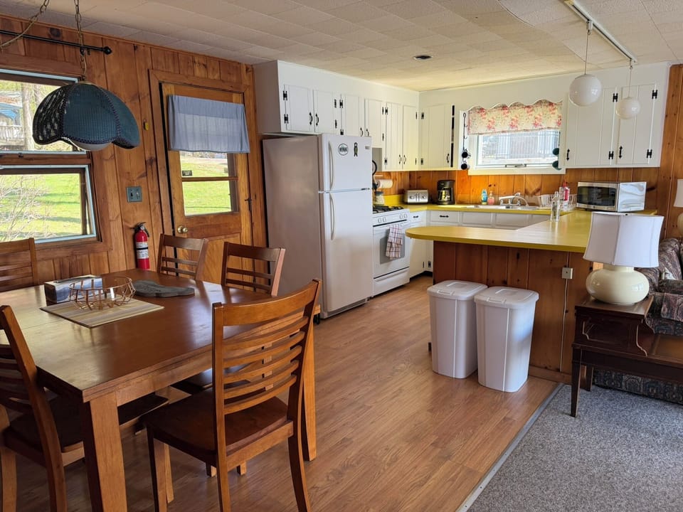 Your fully-equipped kitchen awaits with everything needed for memorable meals together—from morning coffee to family dinners around the warm wooden table.