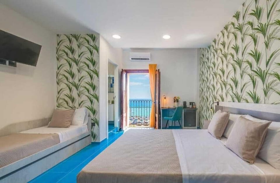 Deluxe Triple Room, Sea View | In-room safe, desk, soundproofing, cribs/infant beds
