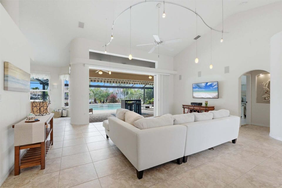 Large living room overlooking the lanai and sparkling pool