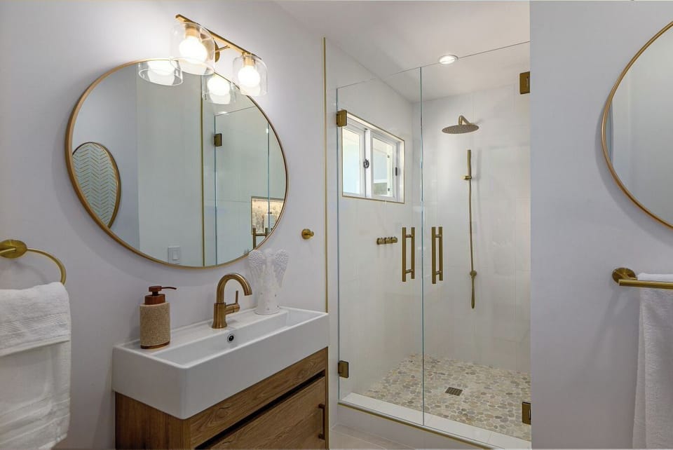 En-suite back bathroom adjoins queen bedroom with TV, garden view and access.
