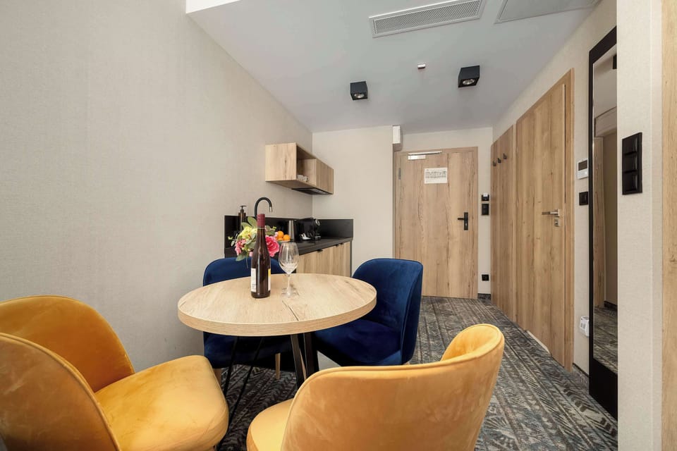 A cozy dining nook with a small round table and chairs. Decorative items add a welcoming touch to the space.
