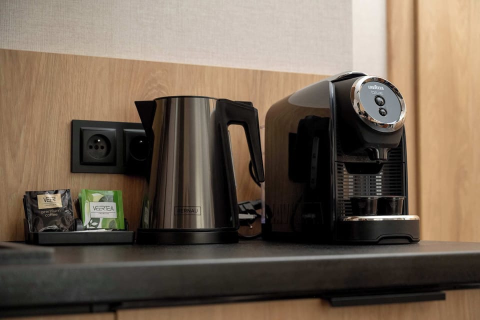 A close-up of a coffee machine and kitchen countertop. The space is designed for convenience and comfort.