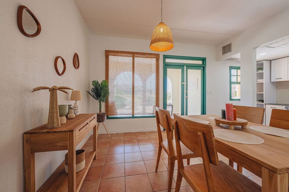 Bright, cozy dining area with rustic wood, terracotta floors, and natural light perfect for relaxed meals.