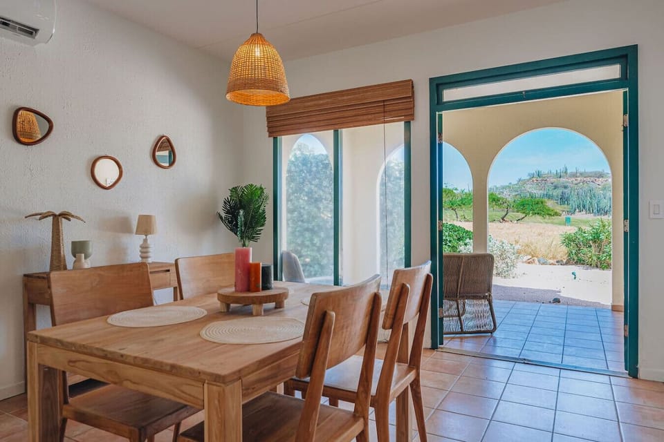 Bright dining space with rustic charm and terrace views perfect for relaxed meals and scenic moments.