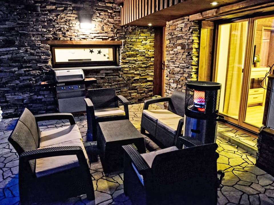 Living Room, Chair, Stone Wall, Wood Stain, Hearth, Hotel, Couch, Armrest, Coffee Table