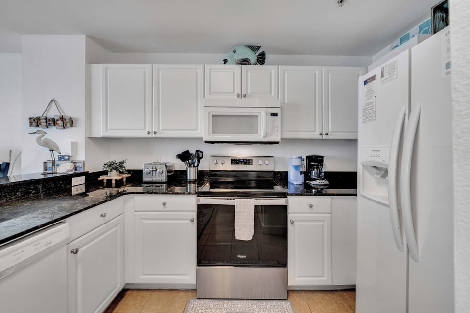 The fully equipped kitchen features granite countertops and has everything you need to prepare meals for family & friends.