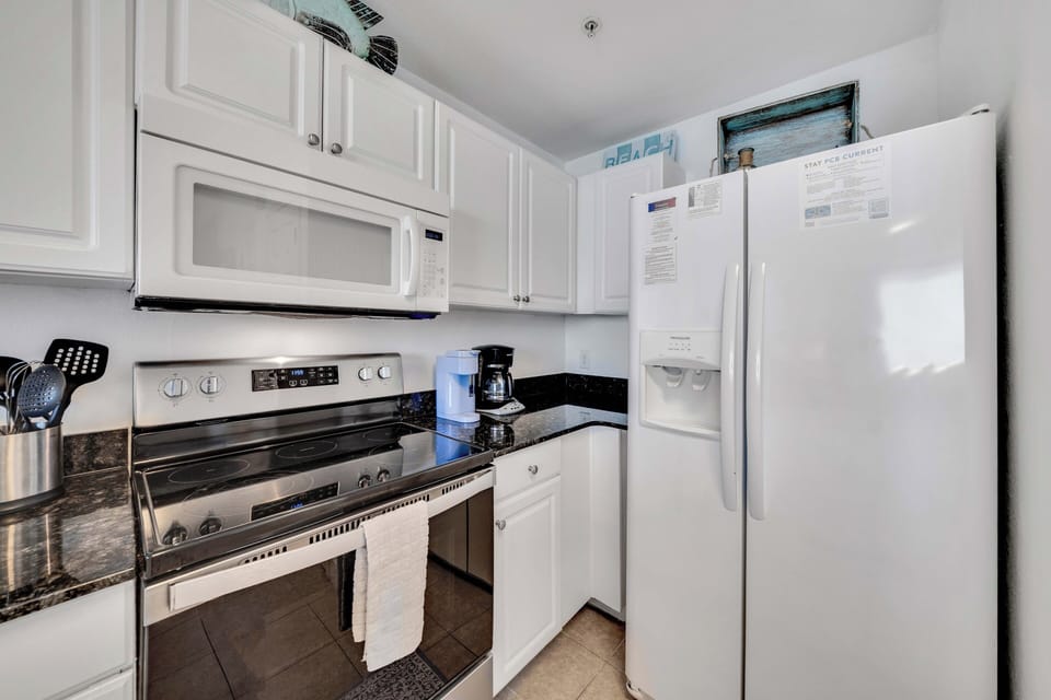 The fully equipped kitchen features granite countertops and has everything you need to prepare meals for family & friends.
