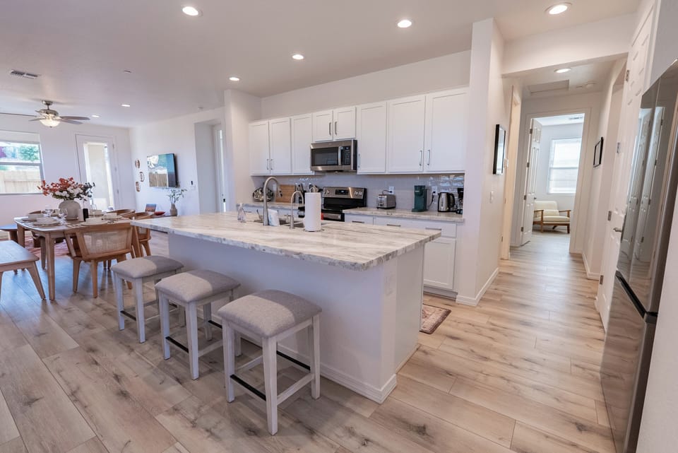 Open kitchen with marble countertops and new appliances