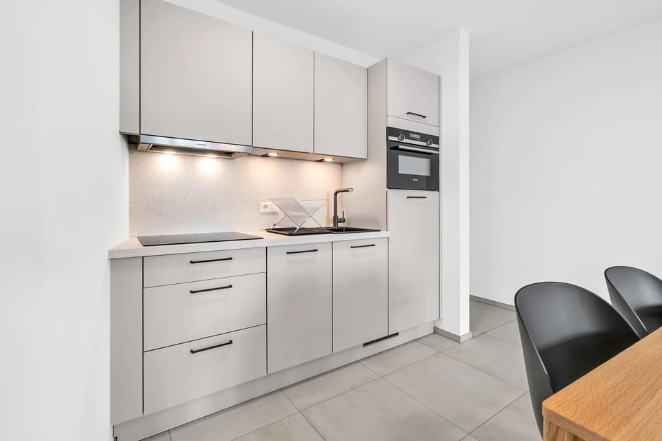 Sleek kitchen design with ample storage, modern appliances, and a clean minimalist style.