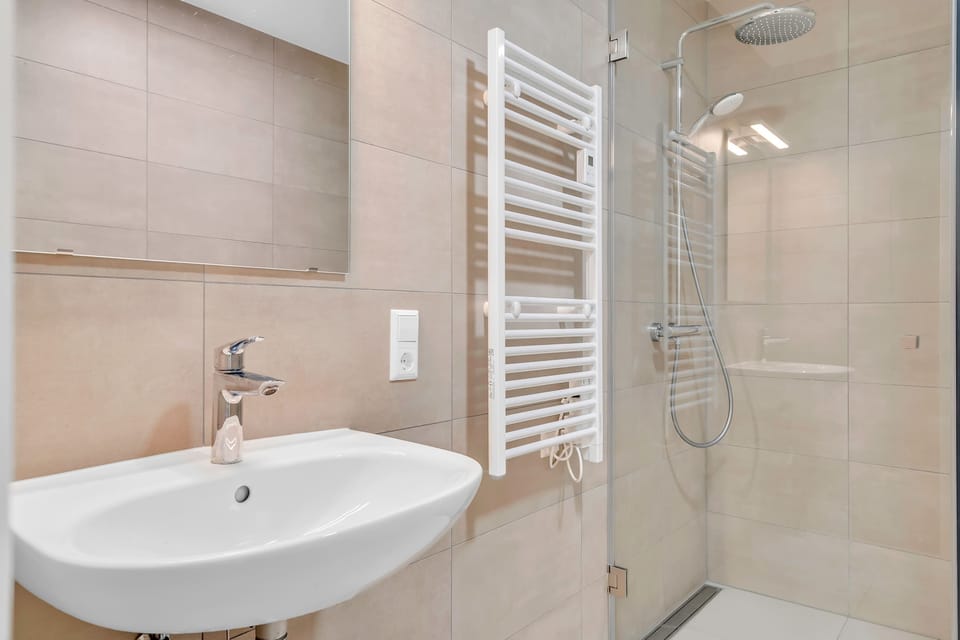 Modern bathroom with walk-in shower, clean finishes, and all essentials for a comfortable stay.