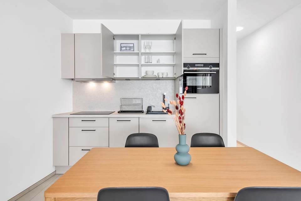 Fully equipped kitchen with dining area, perfect for preparing meals and enjoying time together.
