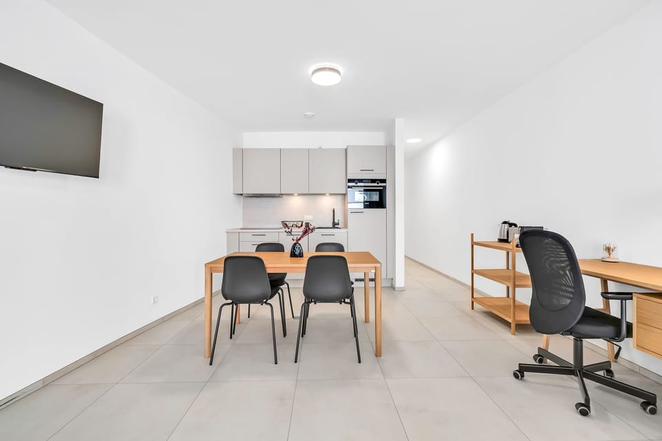 Open layout with workspace, dining table, and kitchen, ideal for both work and relaxation.
