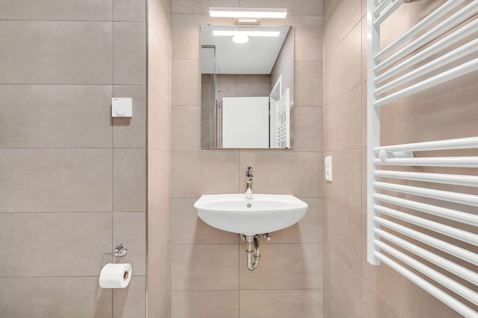 Modern bathroom with walk-in shower and clean, functional design.