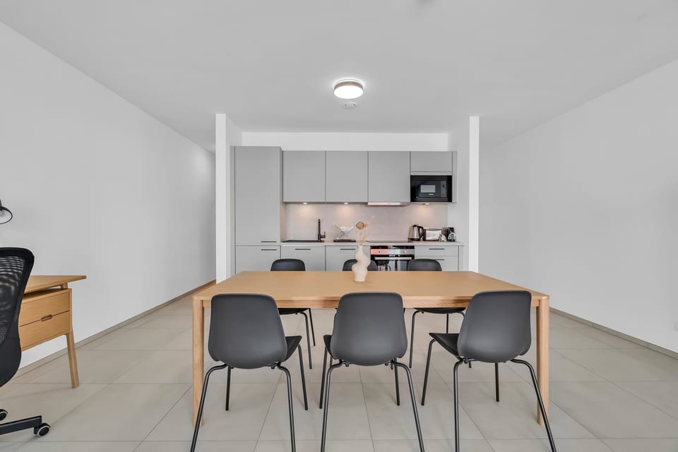 Dining space with modern kitchen setup, ideal for cooking and enjoying meals.
