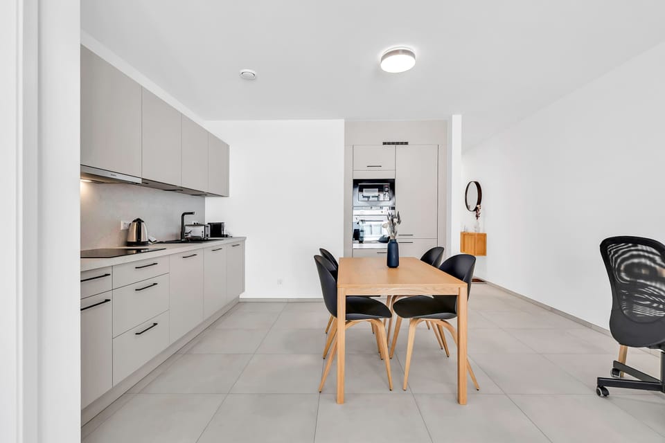 Kitchen and dining area with workspace, ideal for both meals and remote work.