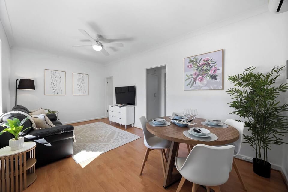 Open-plan living and dining area offering a seamless space to relax, dine, and unwind, with natural light enhancing the layout.