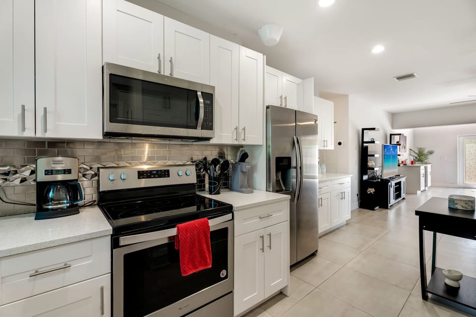 Fully equipped kitchen with stainless steel appliances and ample counter space for meal prep