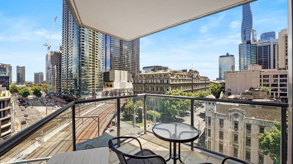 Relax on the balcony with outdoor seating and sweeping views of the CBD and surrounding architecture.