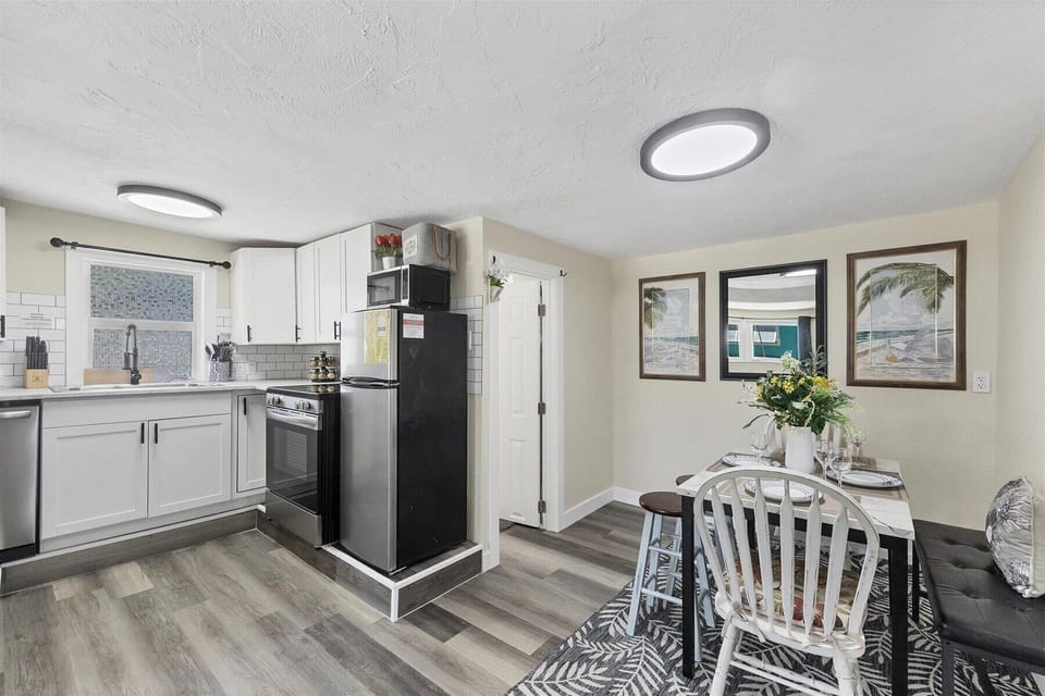 Bright kitchen with subway tile, stainless accents & cozy dining nook
