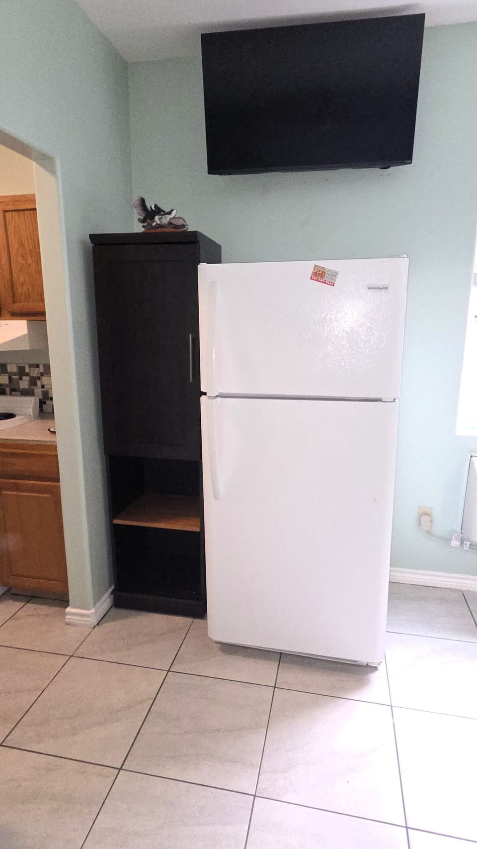 There is a full-size refrigerator freezer and small pantry as well.
