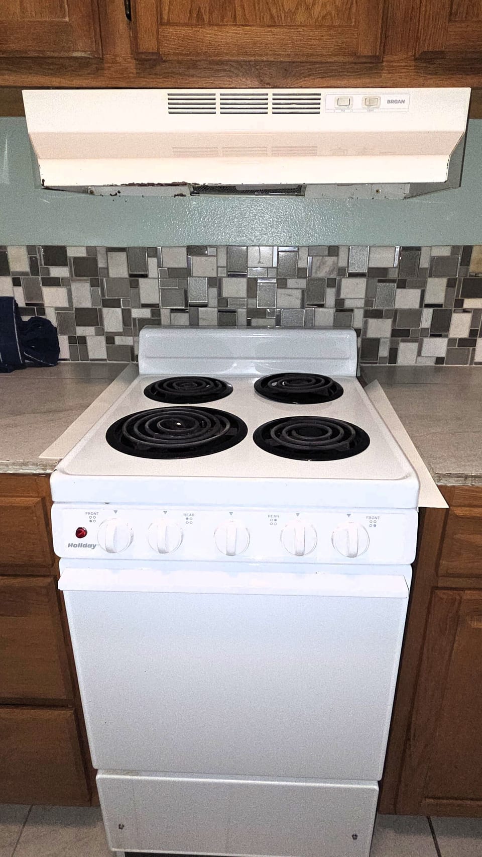 The kitchen has a small range and oven.