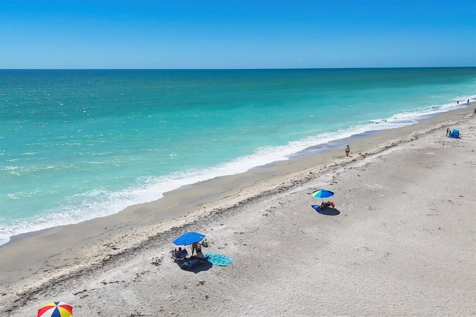 Uncrowded sugar-sand beach with turquoise water—steps from your stay