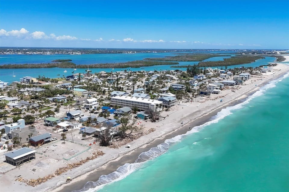 Steps to sugar-sand beach on turquoise Gulf—island getaway
