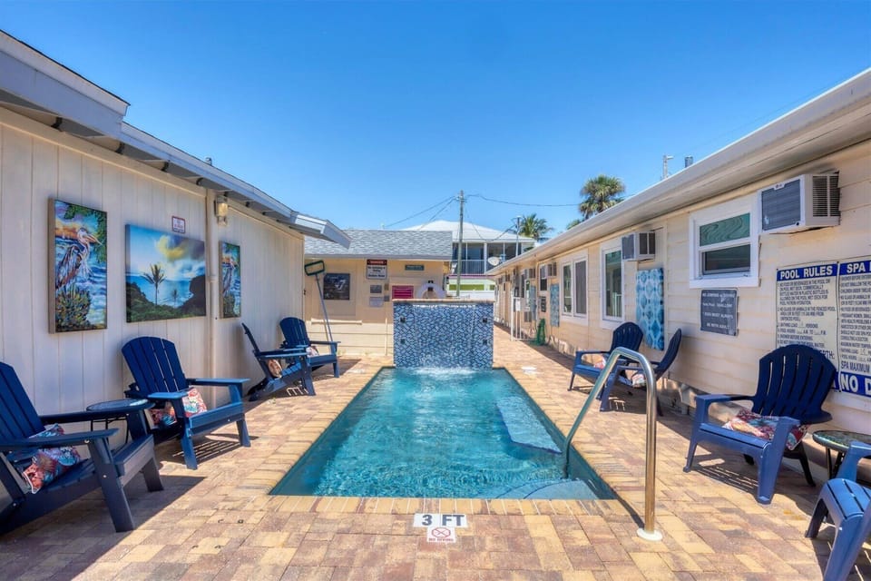 Sunny courtyard with 3‑ft plunge pool, waterfall and Adirondack seating
