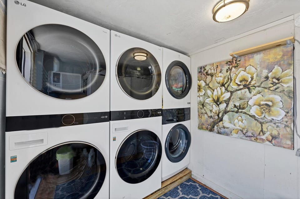 Three LG washer/dryer pairs in a bright, stylish laundry room—easy stays.