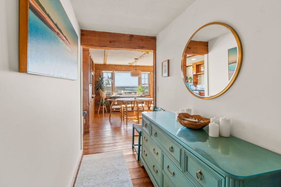 Open concept dining area with seating for 6. This area leads directly into the living room, with the fully equipped kitchen right around the corner.