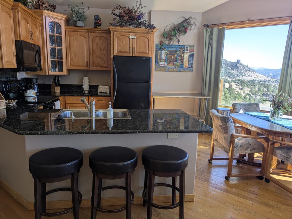 Fully stocked kitchen with drip coffee maker, dishwasher, range, fridge, pots, pans, baking sheets, 