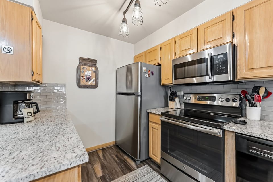  Kitchen: Drip coffee maker, Crockpot, blender, toaster, cooking utensils, tableware 

