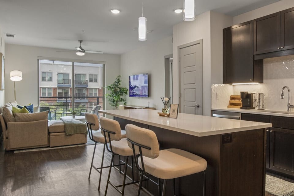 Open-concept layout connecting the kitchen, living room, and private patio