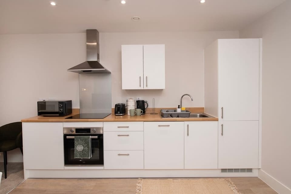 Our kitchen is fully equipped with a cooker, toaster, kettle, and plenty of cooking essentials—perfect for preparing hearty breakfasts or relaxed evening meals. The space is open-plan, flowing seamlessly into the living room and dining area.