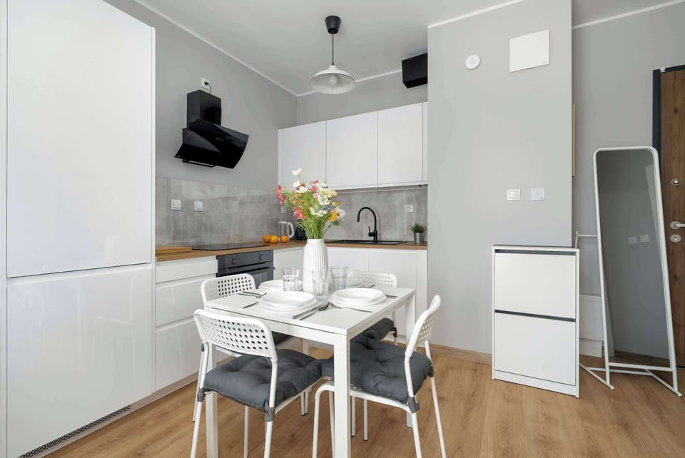 The sleek design of the kitchenette blending seamlessly with the living area.