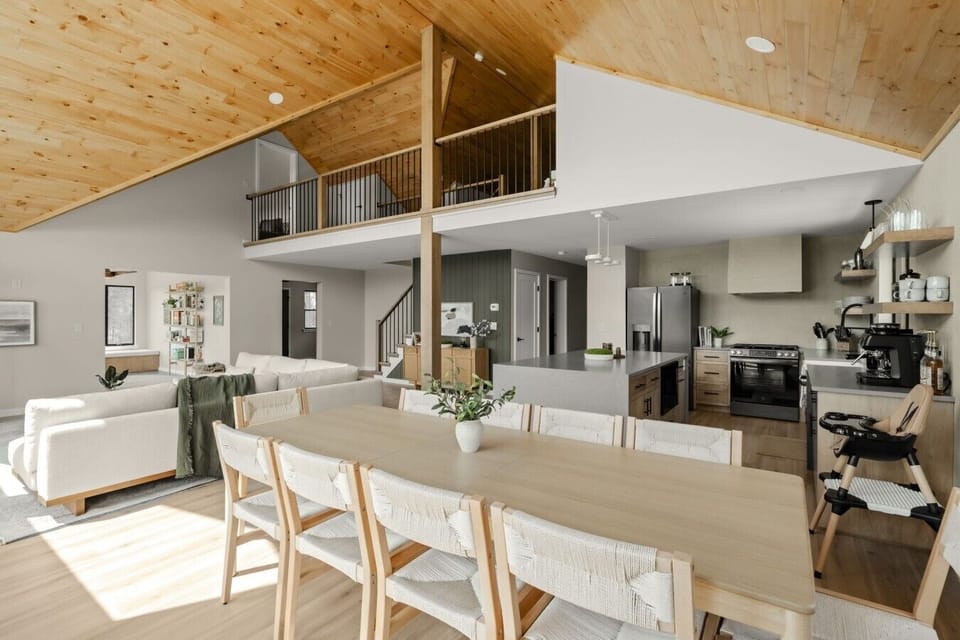 Gather around the spacious dining table, surrounded by natural light and peaceful woodland views
