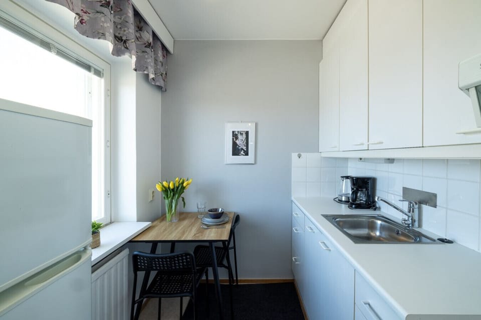 A bright and functional kitchen featuring a cozy dining nook by the window.