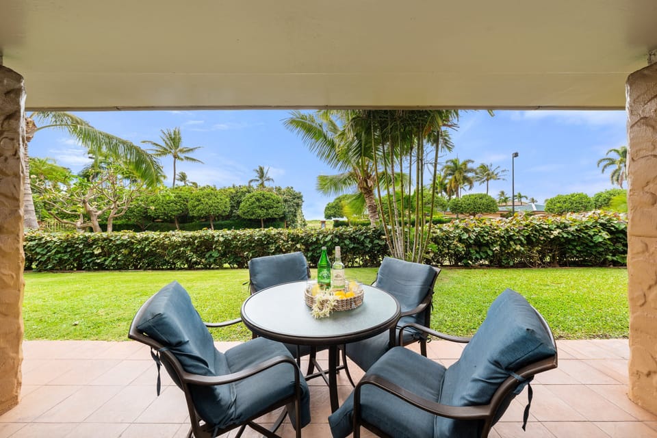 A peaceful outdoor retreat with a cozy dining table surrounded by vibrant tropical landscaping.