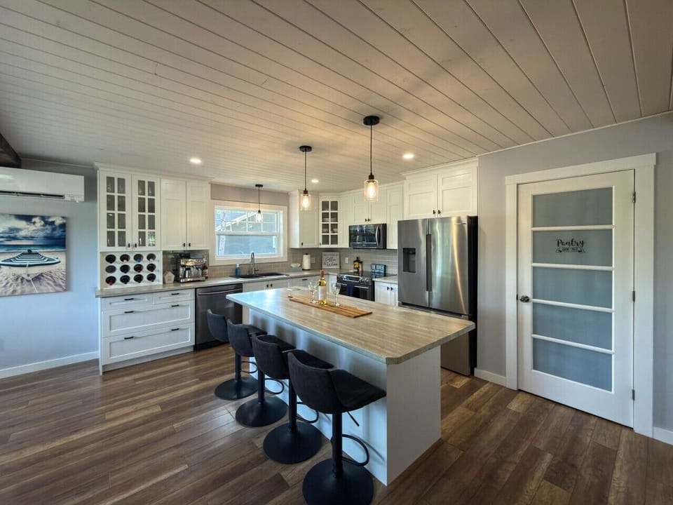 Fully stocked kitchen with island seating.