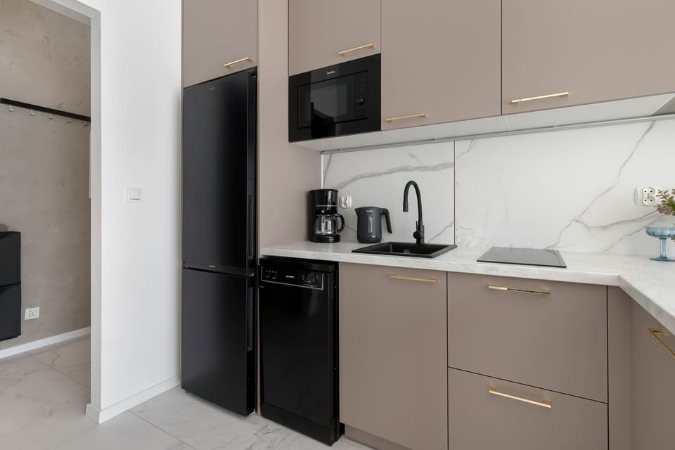 A kitchen view featuring a refrigerator, cabinets, and a tidy cooking space.