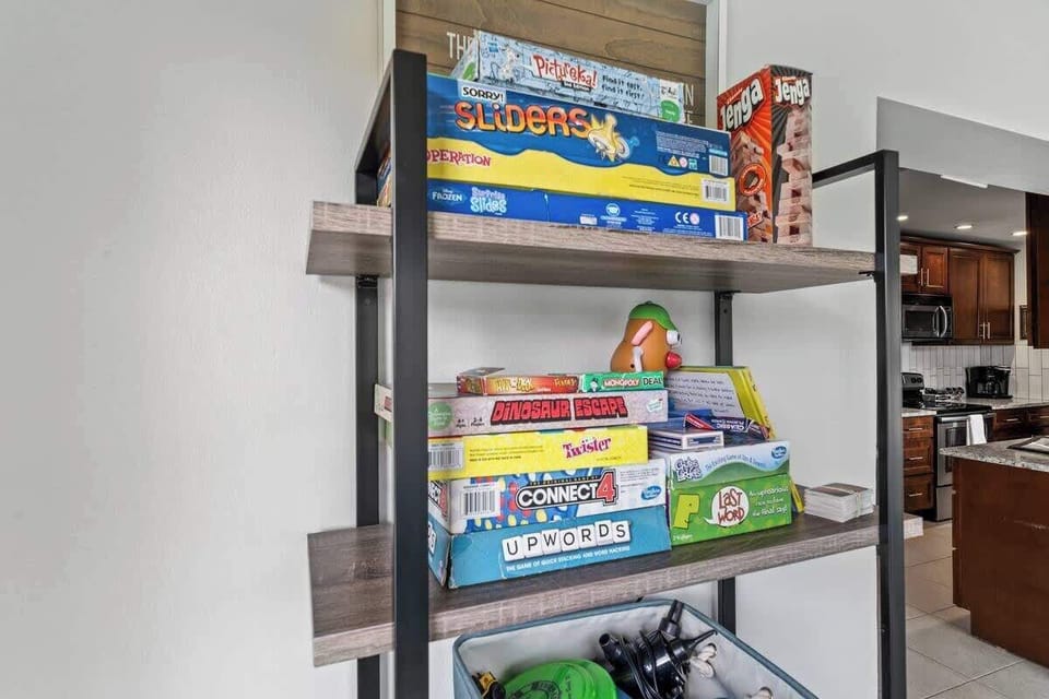 Shelf stocked with classic board games for family-friendly entertainment.