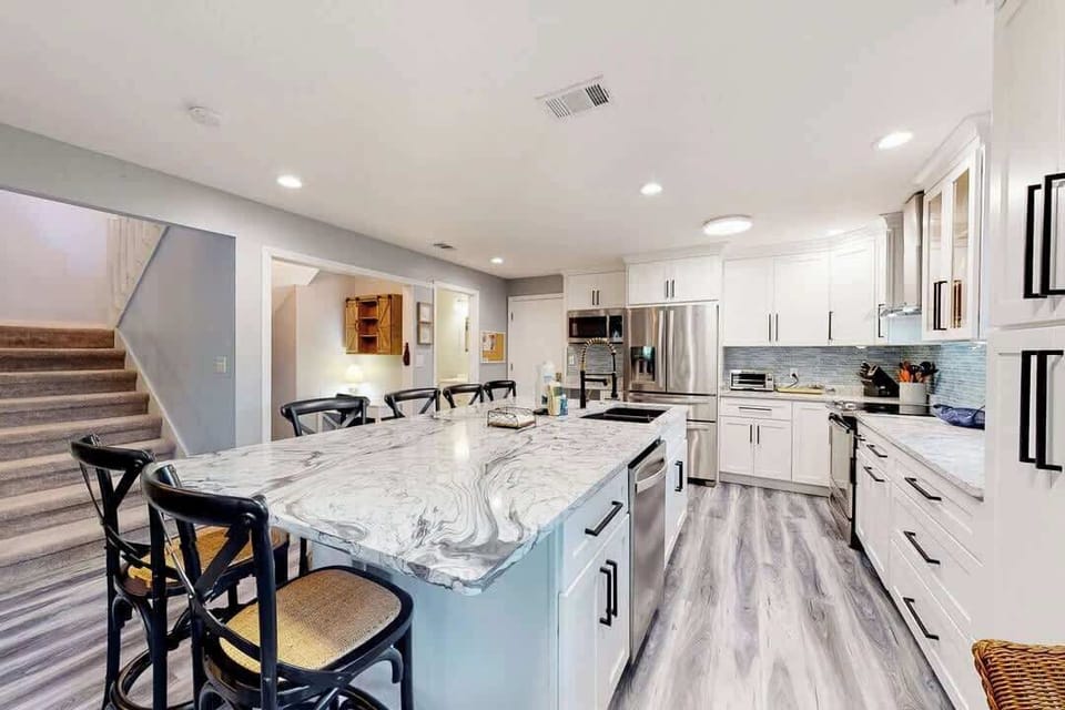 Modern kitchen with a large marble island and stainless steel appliances