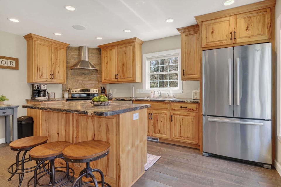 You'll love cooking in this warm, rustic kitchen with granite countertops, stainless steel appliances, and charming wood cabinets.