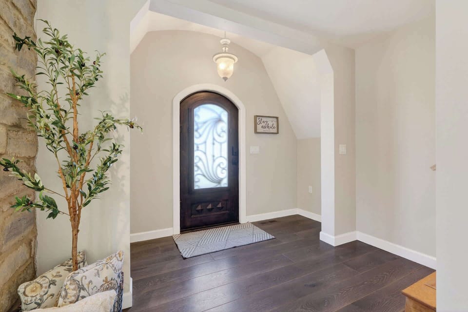 Step into this bright, welcoming entrance with elegant archway and warm hardwood floors that set the tone for your stay.
