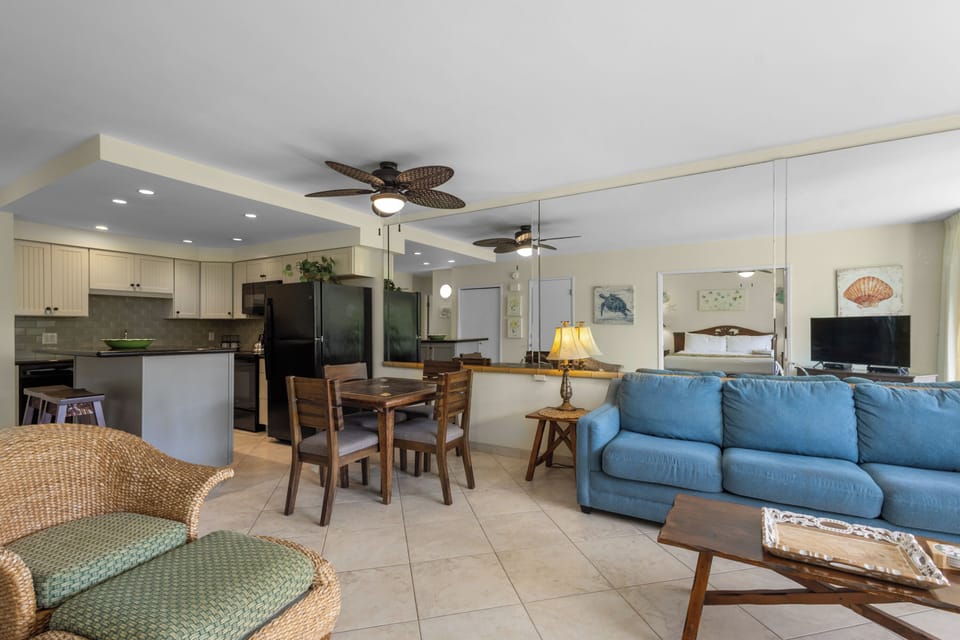 Your bright, open-concept retreat blends modern comfort with coastal charm. Relax on the blue sectional while ocean breezes flow through.