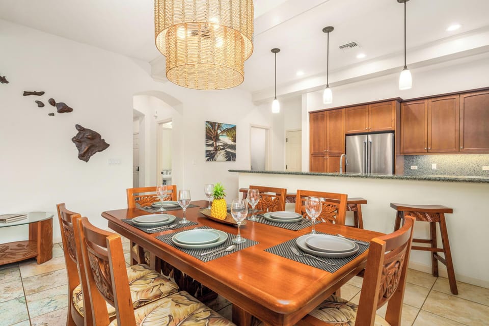 Your elegant dining space features rich wood furnishings and tropical Hawaiian décor, creating the perfect setting for memorable meals together.