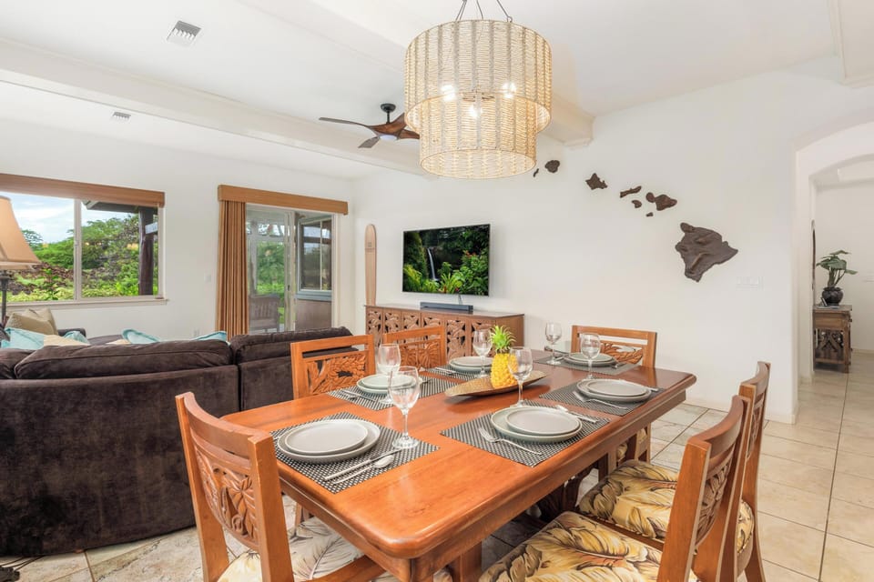 Gather around your elegant dining table for memorable meals while enjoying tropical views through large windows and island-inspired décor.